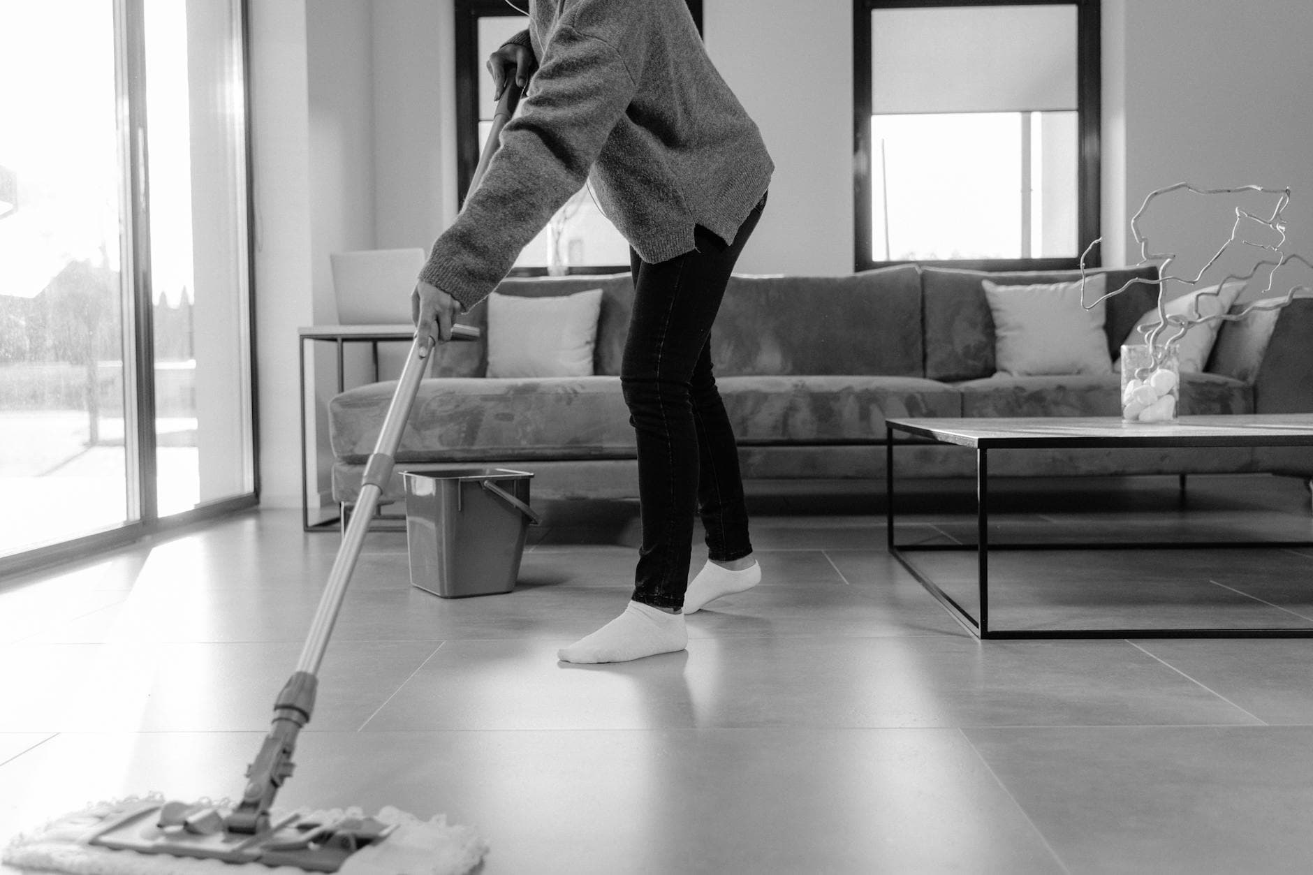 Professional Connecticut cleaner mopping the floor in a modern apartment living room — Weekly Maid Service in Stamford, Fairfield County