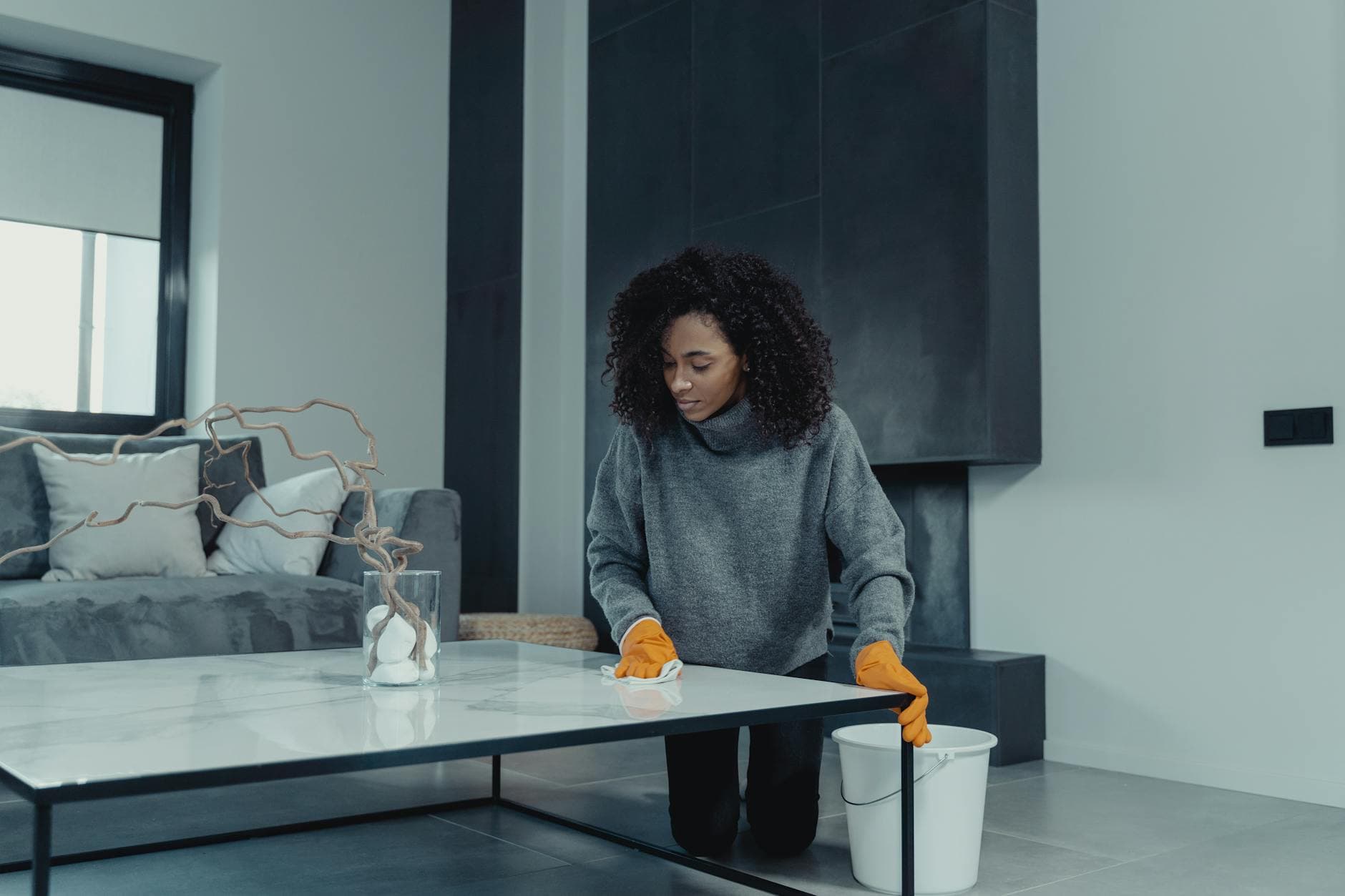Professional house cleaner wiping a table in a contemporary apartment — Bi-Weekly Cleaning in Ridgefield, Fairfield County